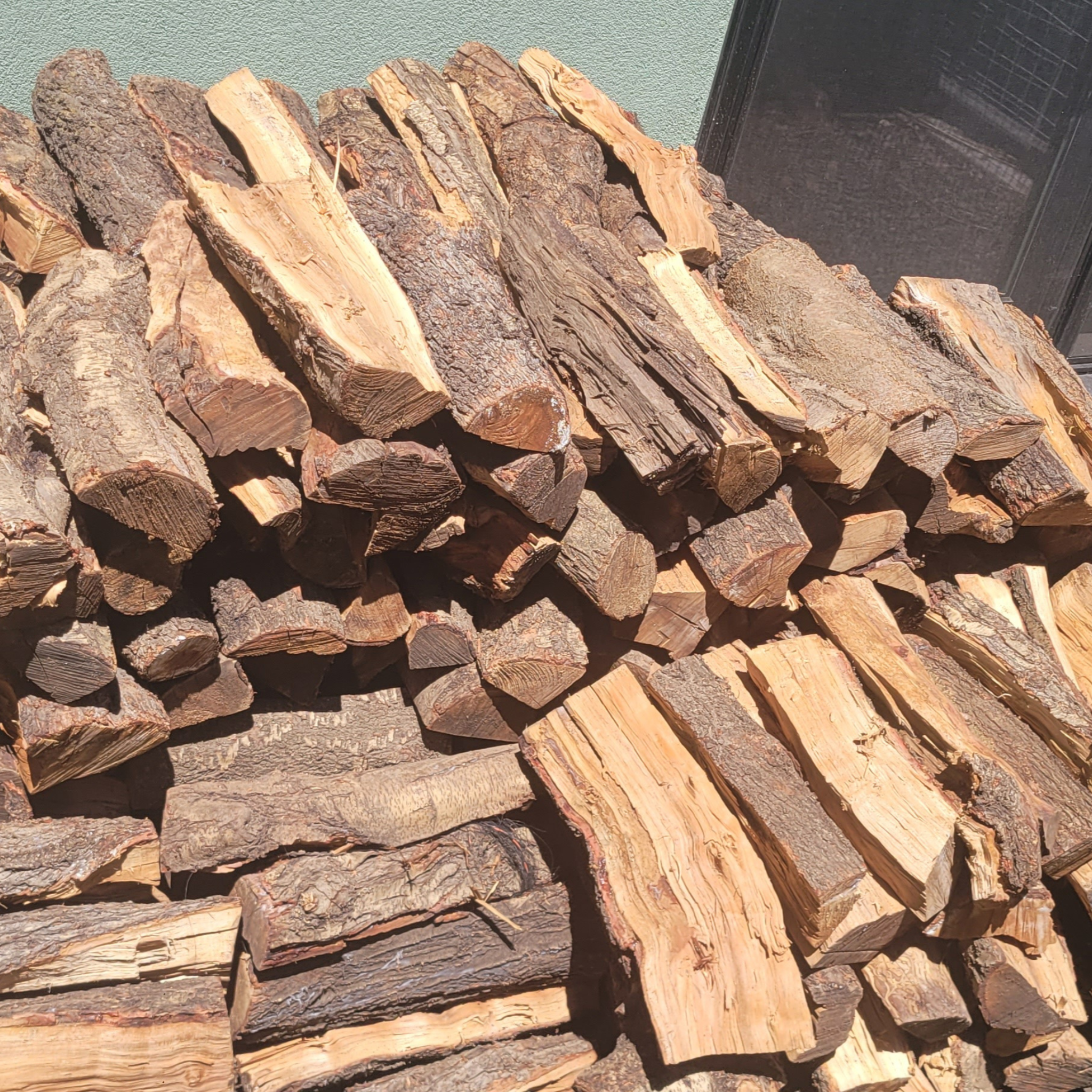 Stack of 16" split firewood logs 