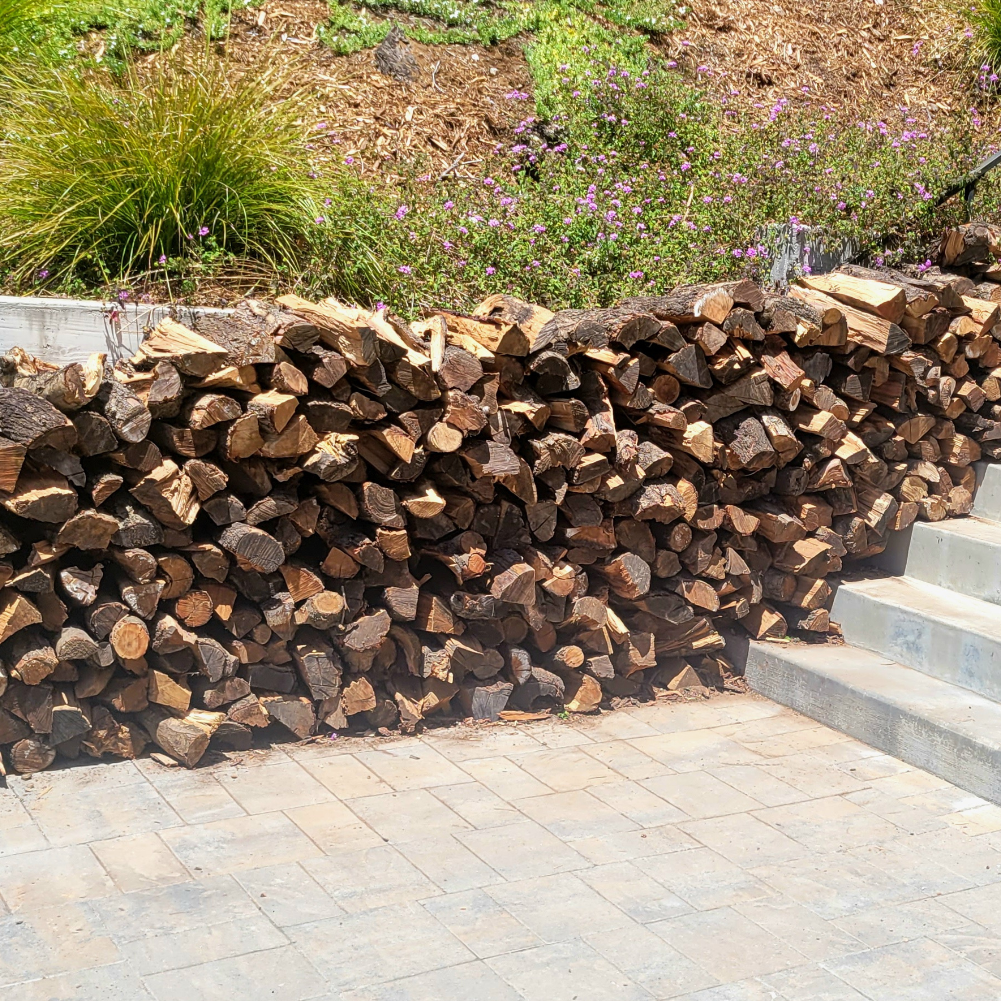 3/4 cord stack of almond firewood up stone patio stairs delivered to Piedmont Ca.